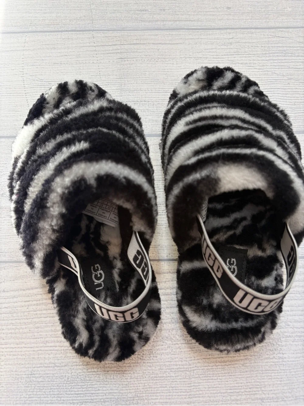 UGG kids Black & White Faux Fur Slide Slippers with Branded Heel Strap